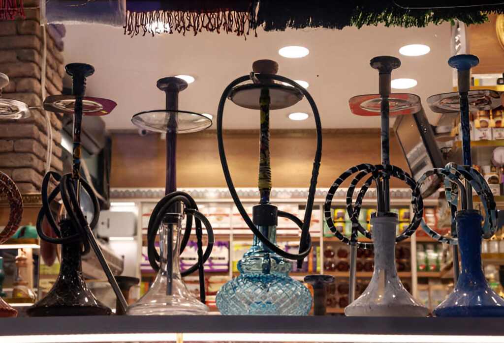 A group of hookahs on a shelf at Pipe King LLC LA Wholesale Smoke Shop and Accessorie