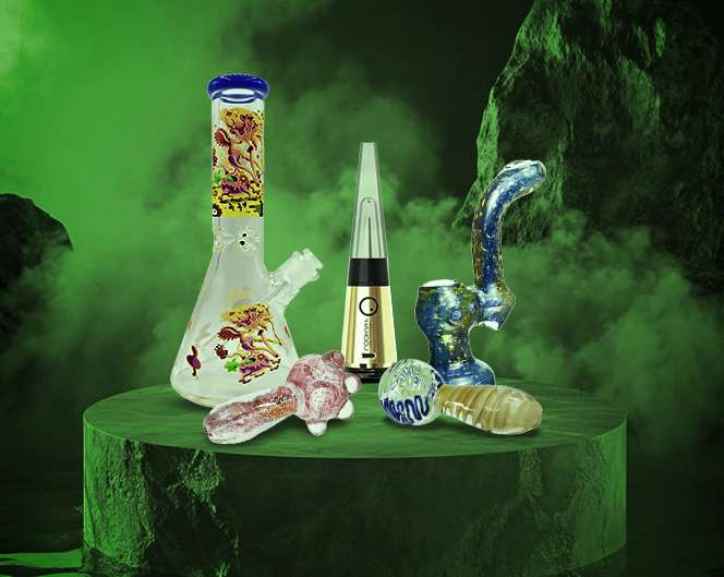 a group of glass bongs on a green surface